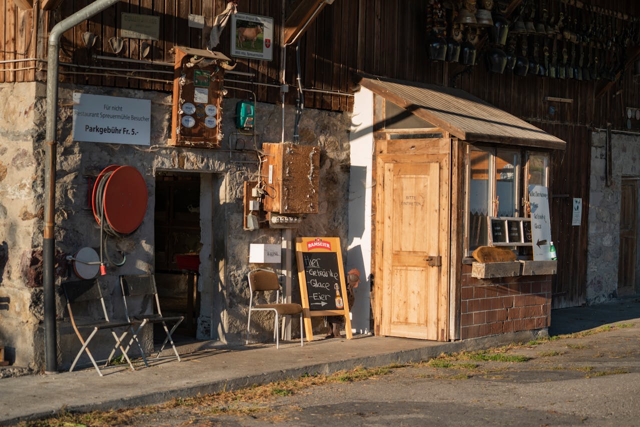 A rustic market stall with wooden details and vintage signage in the warm sunlight, capturing a cozy outdoor scene.