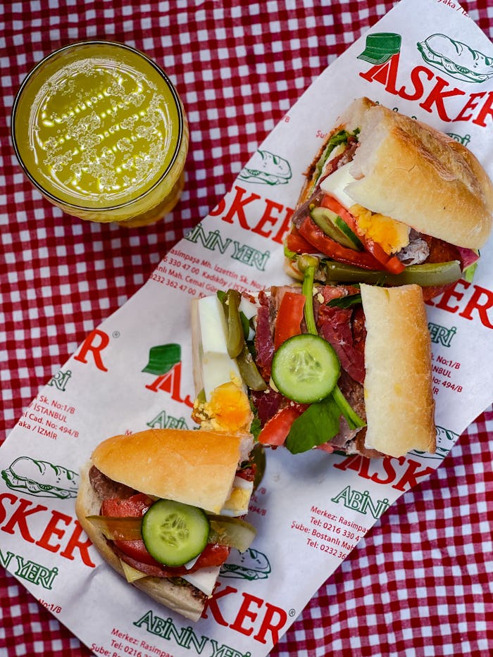 Close-up of Turkish döner sandwich and fresh juice on a picnic table.